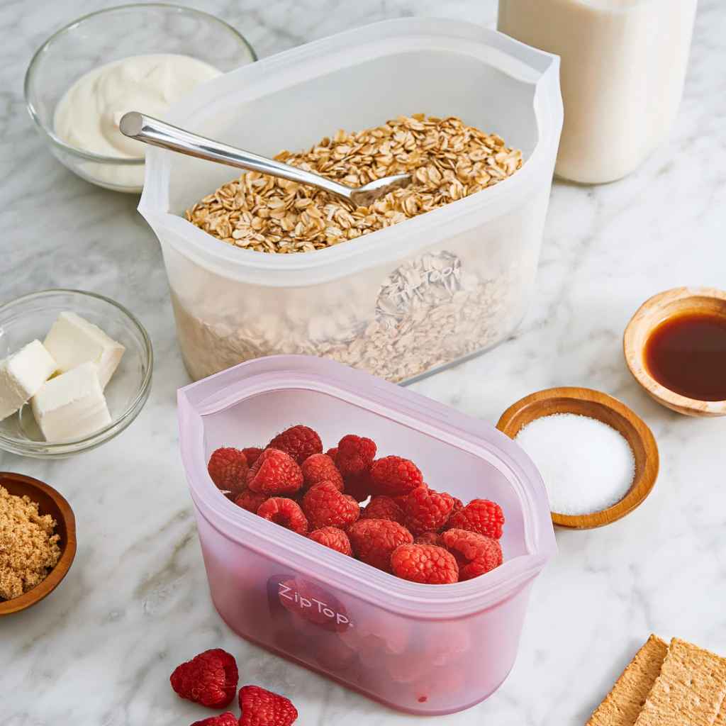 Zip Top 100% Platinum Silicone Reusable Containers, dishes shown with various foods inside as examples (oats, berries).