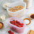 Zip Top 100% Platinum Silicone Reusable Containers, dishes shown with various foods inside as examples (oats, berries).