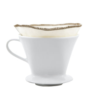 Reusable, organic cotton coffee filters made in the USA. #2 filter size. creme colored with brown threading, shown inside pour over ceramic mug