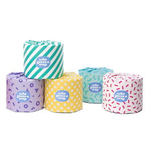 5, 3 ply "who gives a crap" toilet paper rolls, each with a multicolored/multi patterned package design