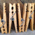 close up of 5 clothespins displayed vertically in front of rustic reclaimed wood