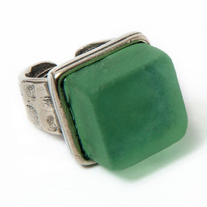 Close up of a green recycled glass cocktail ring with a square stone and a and pewter band