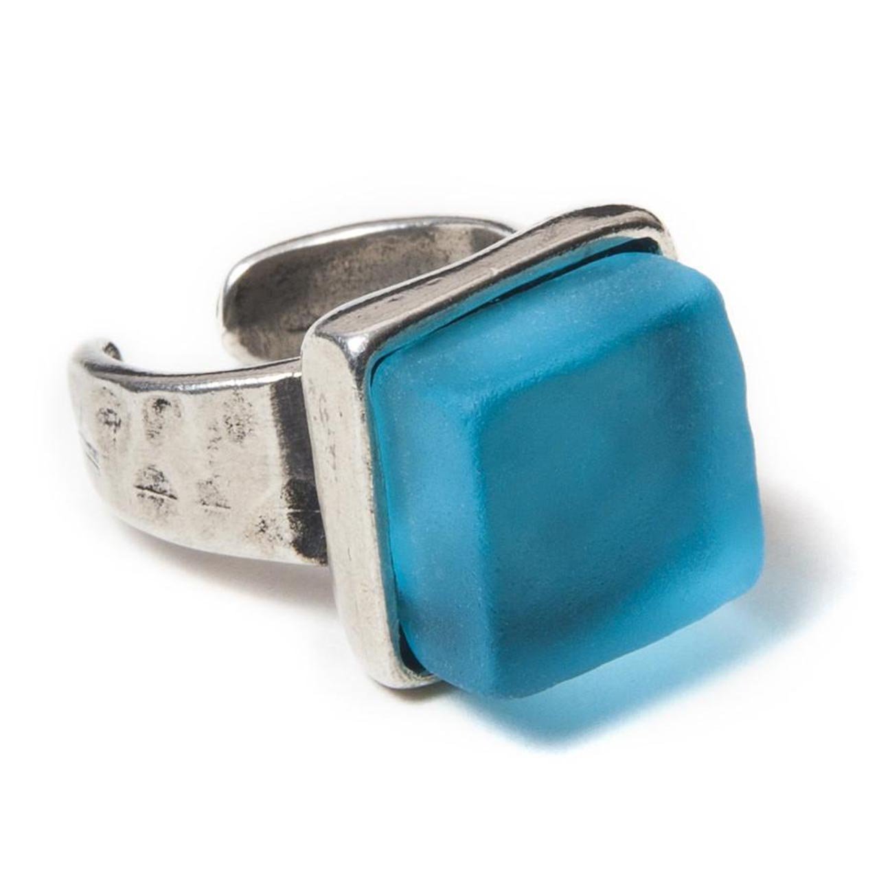 Close up of a light blue recycled glass cocktail ring with a square stone and a pewter band