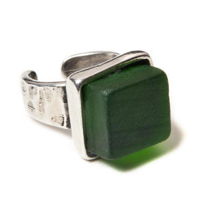 Close up of a dark green recycled glass cocktail ring with a a square stone and a pewter band