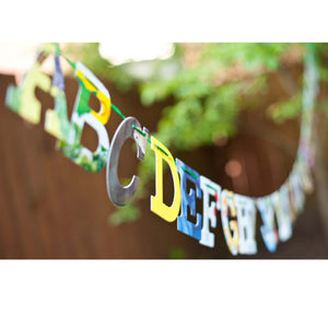 Alphabet displayed hanging outside in sunny backyard party