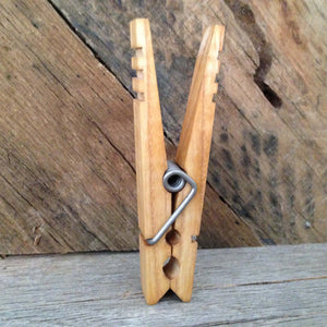 clothespin displayed vertically in front of rustic reclaimed wood