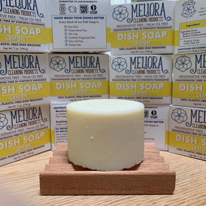 7 oz dish soap cylinder on wood table top, surrounded by meliora dish soap packages