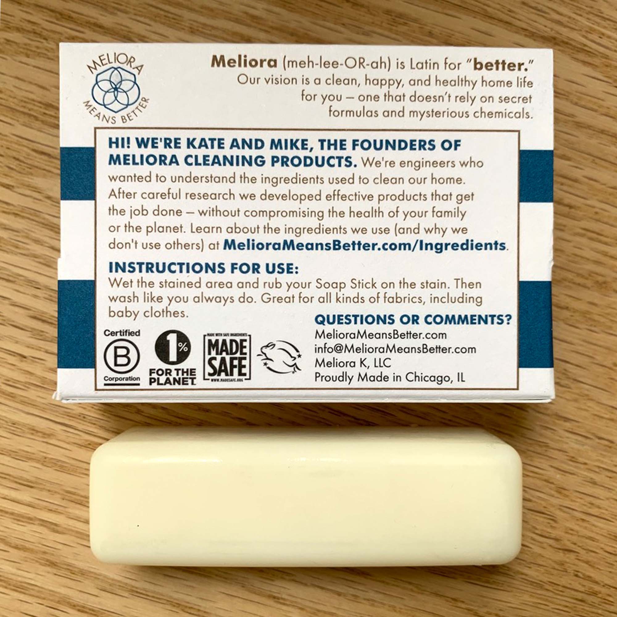 1.7 oz laundry stain removal soap stick package with instructions list, blue and white, with natural colored stick on wood tabletop