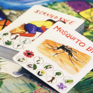 two oversized white game cards, one reads "mosquito bite", the other "scraped knee", both in orange text with illustrated design