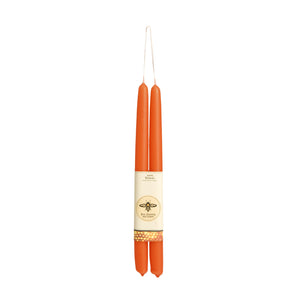 pair of pumpkin colored long taper candles, hung from the wick, wrapped in big dipper logo