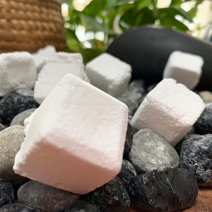 all natural white toilet bombs, cubed, placed on assorted rocks and fossils