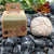 kitchen twine package next to a 200 ft roll, with plants in background