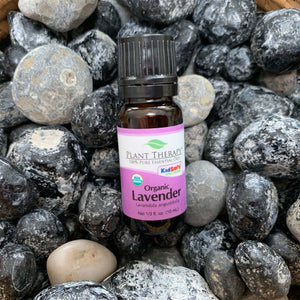black bottle with purple label, reads organic lavender, displayed on assorted rocks. 10 ml
