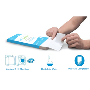 blue tru earth laundry strip package with two hands tearing white laundry strip . graphis read "standard & HE machines, hot & cold water, dissolves completely