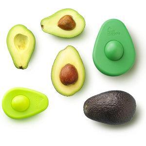 2.5 avocados, three slices, two avocado huggers, one large dark green, one small light green