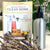 Aluminum spray bottle pictured with "the Naturally Clean Home" book