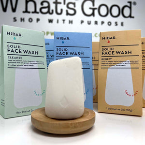 single cleanse face wash bar on bamboo soap dish with boxes of Cleanse, Hydrate, and Renew options behind. 