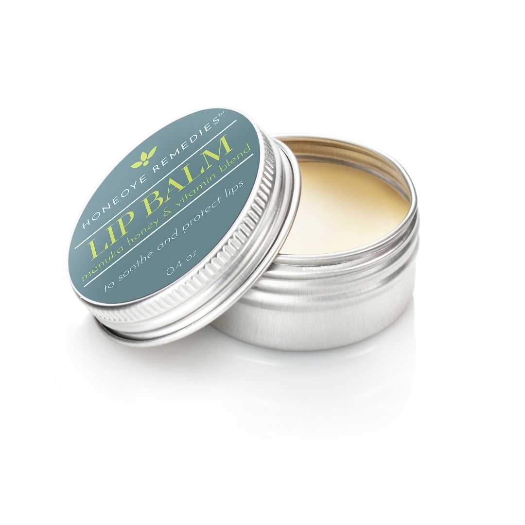 lip balm tin partially open to reveal 100% natural lip balm on white background