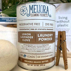 Meliora laundry powder container frontside with dryer ball and clothespin.