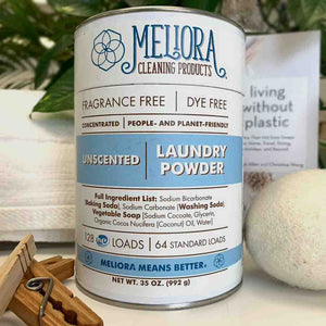 meliora laundry powder container front with towel, dryer ball, clothespin.