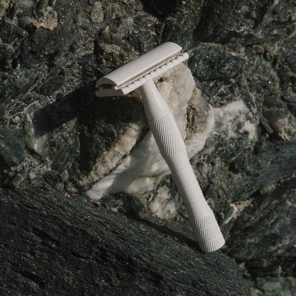 Safety razor. Weighty brass. Cream color. Includes one stainless steel blade. Gives a smooth, irritation-free shave for every part of the body. Works with standard safety razor blades. Made in Canada. Woman-owned business.